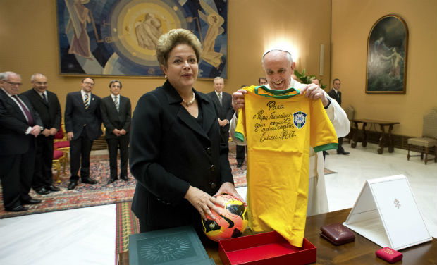 In this photo provided by the Vatican newspaper L'Osservatore Romano, Pope Francis exchanges gifts with Brazilian President Dilma Rousseff during their audience at the Vatican on Friday - AP In this photo provided by the Vatican newspaper L'Osservatore Romano, Pope Francis exchanges gifts with Brazilian President Dilma Rousseff during their audience at the Vatican on Friday - AP